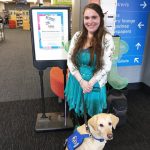 girl wearing blue dress with golden retriever